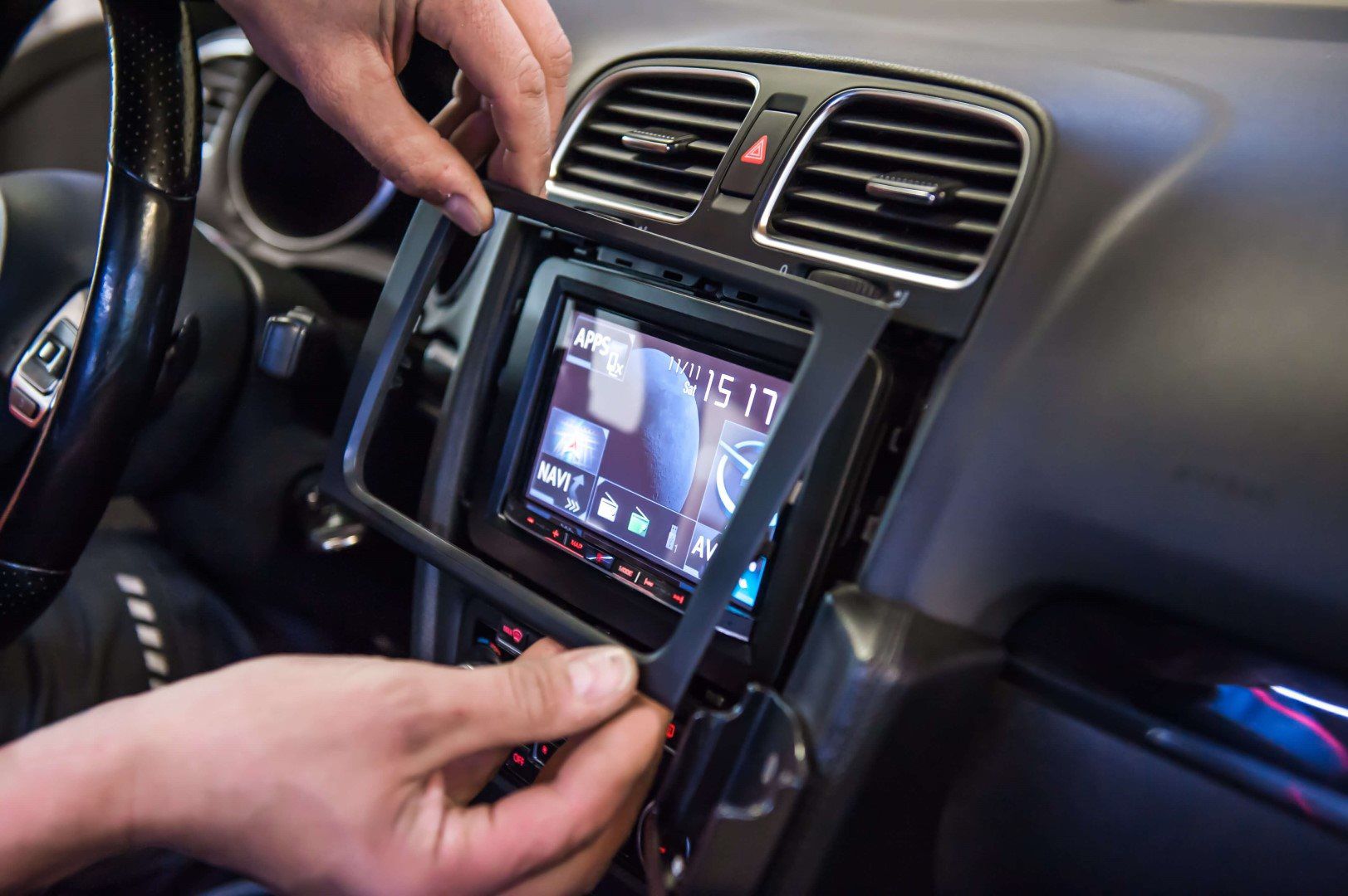 Technician installing car stereo head unit at GT Car Audio